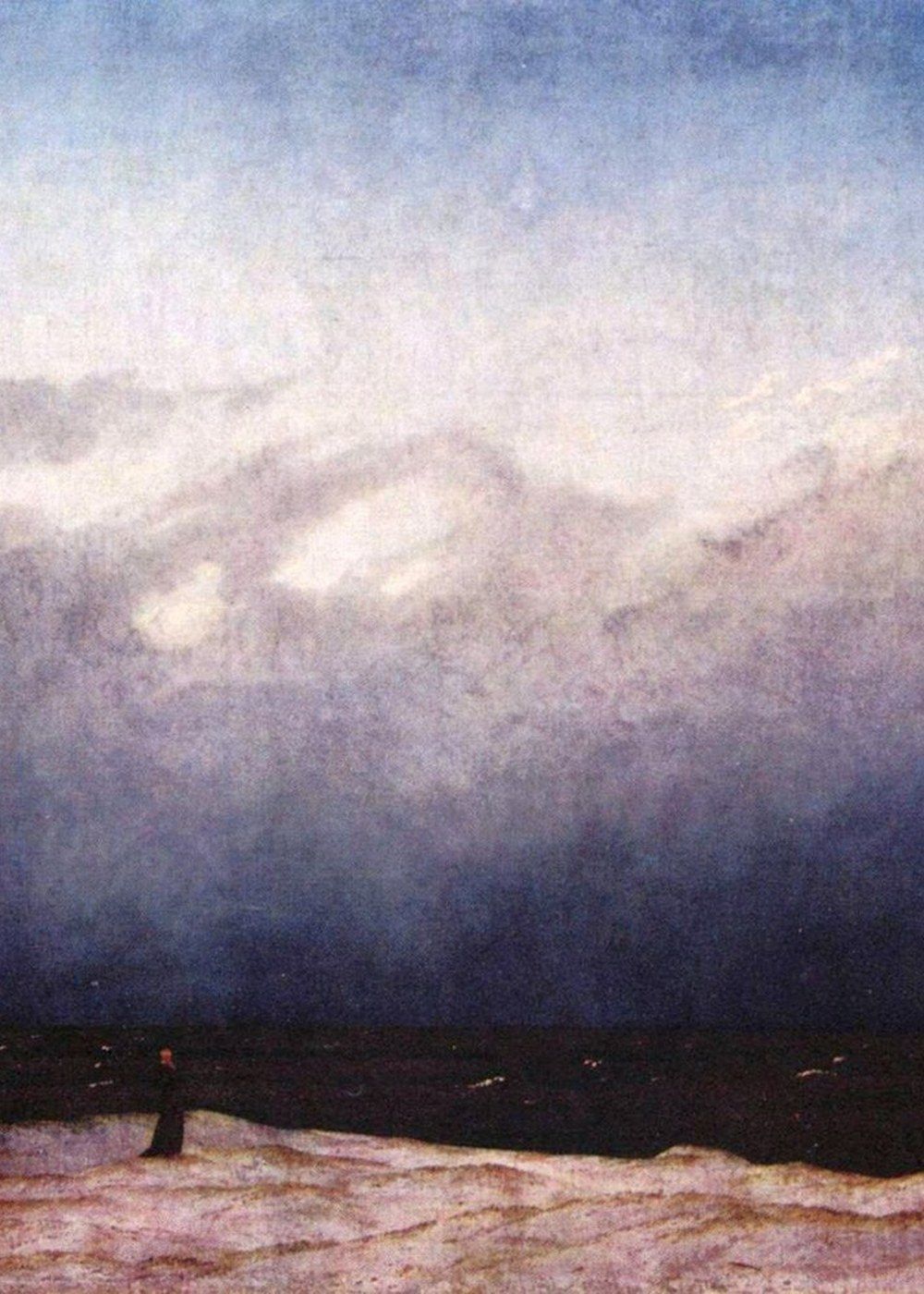 A solitary monk before a vast sea.