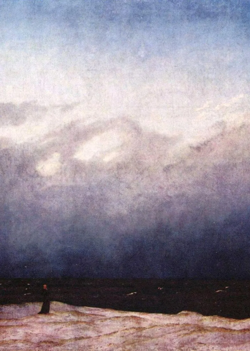 A lone figure stands small against a vast, near-empty sky and dark sea.
